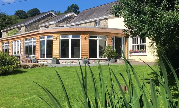 The Guest House from the Garden looking at the Garden room and dining area